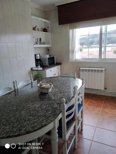 a kitchen with a granite counter top in a room at Gonsa 1 in Padrón