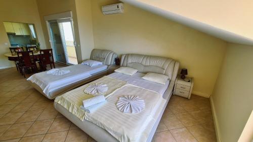 two beds in a room with a staircase at Apartments Villa Astra & Pinija in Brela