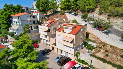 an overhead view of a building with cars parked in a parking lot at Apartments Villa Astra & Pinija in Brela