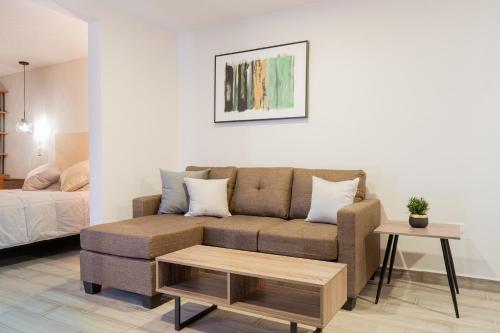 a living room with a couch and a coffee table at Casa Guillermina in Durango