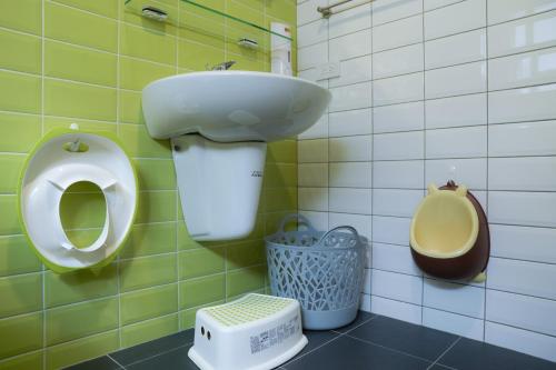 a bathroom with a sink and a toilet at 耶伊親子溜滑梯民宿 in Tainan