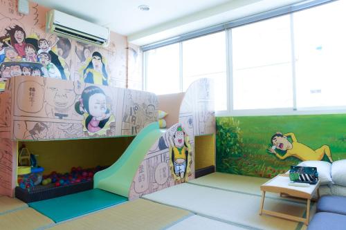a childrens room with a play area with a slide at 耶伊親子溜滑梯民宿 in Tainan