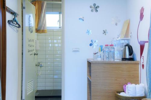 a bathroom with a shower and a sink at 耶伊親子溜滑梯民宿 in Tainan