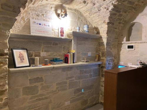a room with a stone wall with a shelf at B&B Il Giardino Nascosto in Roseto Valfortore