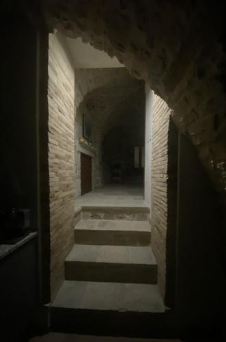 a hallway with stairs in a stone building at B&B Il Giardino Nascosto in Roseto Valfortore