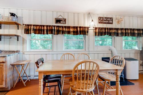a dining room with a wooden table and chairs at 20 Island Drive in Madison