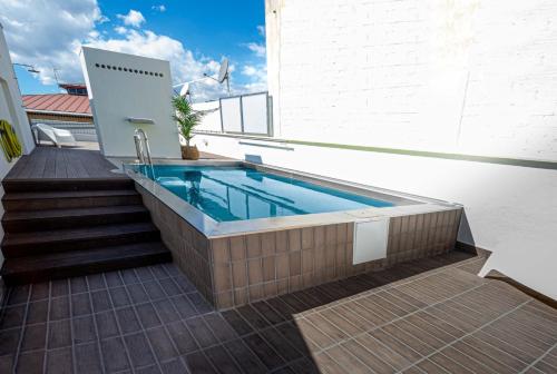a swimming pool on the roof of a building at BARCELONA TOUCH APARTMENTS - Rosich in Hospitalet de Llobregat