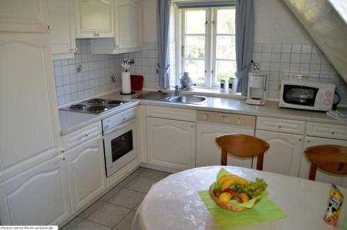 a kitchen with a table with a bowl of fruit on it at Lee - a05409 in Dunsum