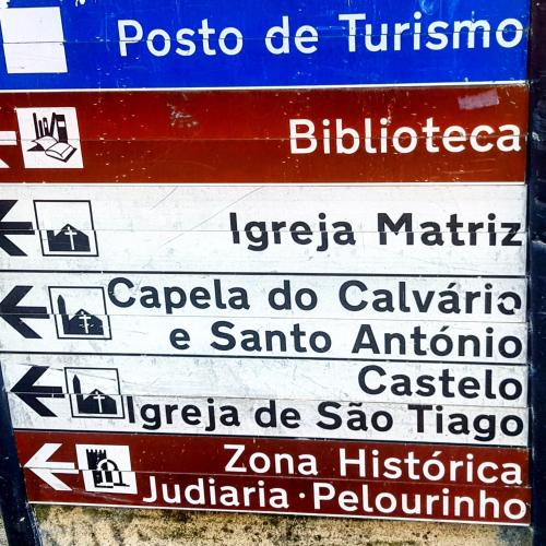 a street sign with a bunch of signs on it at Casa Bento Teixeira in Belmonte