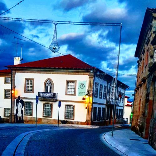 a man standing in front of a building on a street at Casa Bento Teixeira in Belmonte