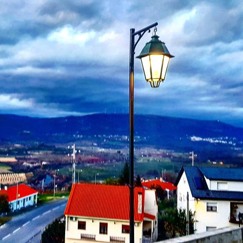 a street light on a pole with a red roof at Casa Bento Teixeira in Belmonte