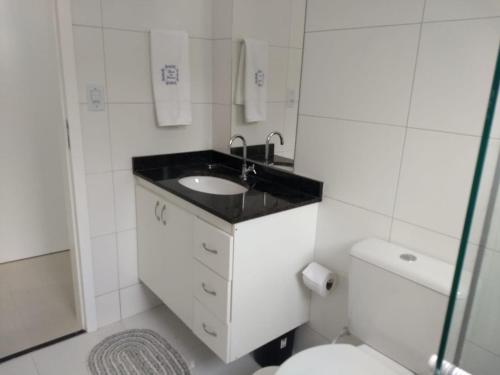 un bagno bianco con lavandino e WC di Cobertura Fort do Pontal ad Arraial do Cabo