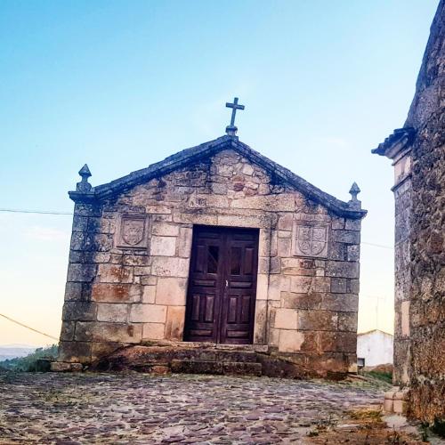 an old church with a cross on top of it at Casa Dr. Saba in Belmonte