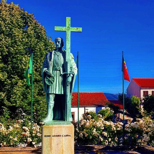 a statue of a man standing next to a cross at Casa Dr. Saba in Belmonte