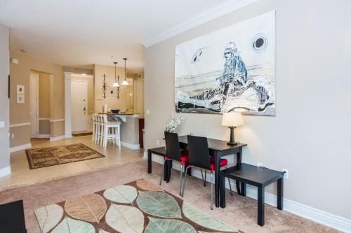 a living room with a table and chairs and a kitchen at Spacious Vista Cay Condo near Universal Studios in Orlando