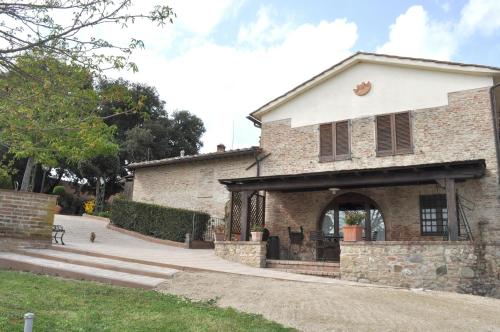 a large brick building with a porch at Agriturismo Il Poggiarello in Siena