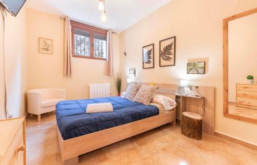 a bedroom with a bed and a desk and a window at Apartamento Turístico Javalambre in Camarena de la Sierra