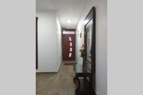 a hallway with a door and a bench in front of it at Panchi´s House in Baños