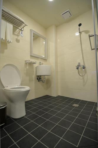 a bathroom with a toilet and a shower at Century Hotel in Kaohsiung