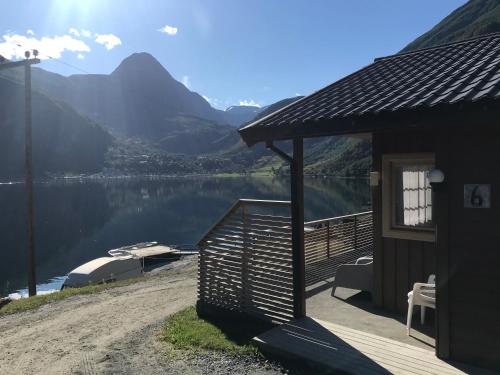 a cabin with a view of a lake and mountains at Solhaug Fjordcamping in Geiranger