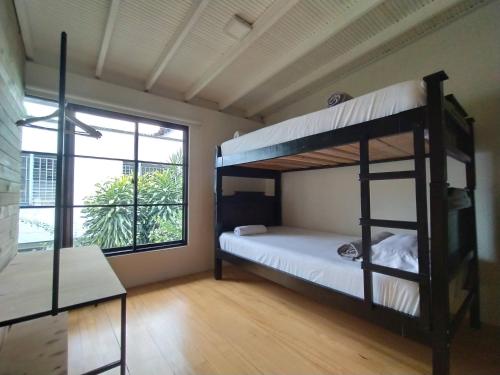a room with two bunk beds and a window at Cloud9 Hostel in Medellín