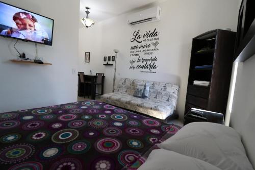 a living room with a couch and a flat screen tv at Departamento Borbon in La Paz