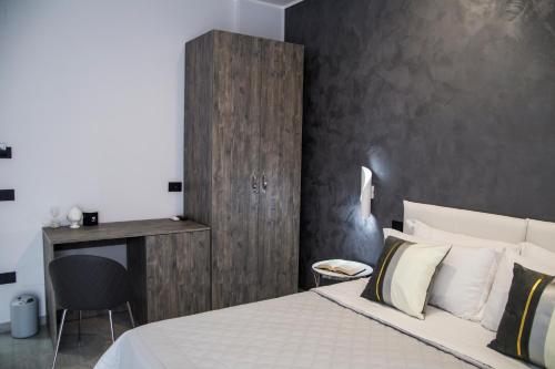 a bedroom with a bed and a desk and a chair at Maison de Julia Pompei in Pompei