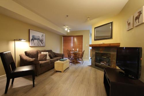 a living room with a couch and a fireplace at Marketplace Lodge by Whistler Retreats in Whistler