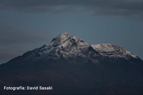 a mountain peak with a blue sky in the background at Hospedaje Wiruyana in Cotacachi