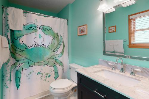 a bathroom with a shower curtain with a crab on it at Beach Dreamer #4-BB in Buxton