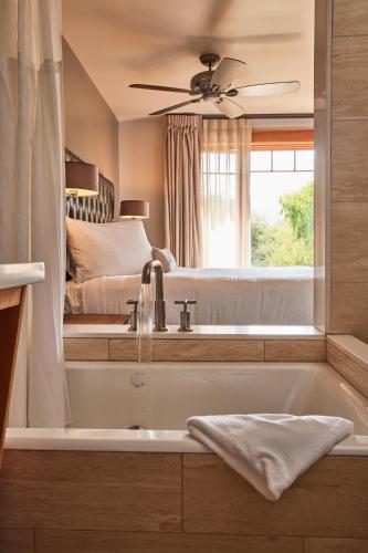 a bathroom with a bath tub and a bed at Olema House at Point Reyes in Olema