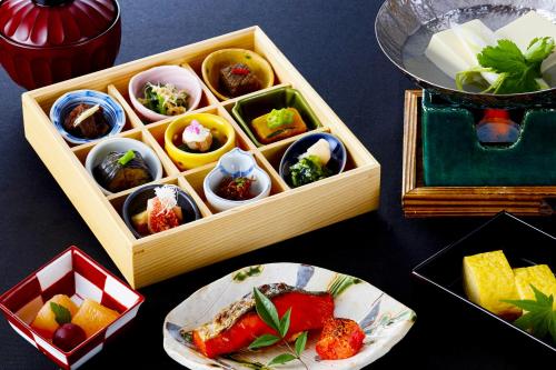 a table with a box of food and a plate of food at Ryokan Sanga in Kyoto