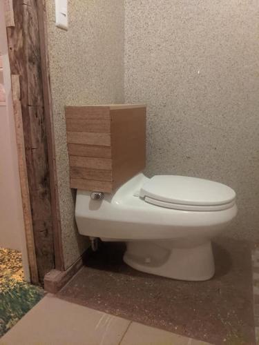 a toilet with a cardboard box on top of it at Mamallacta Páramo Lodge in Papallacta