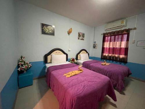 a room with two beds with bananas on them at Diamond Resort in Kanchanaburi City