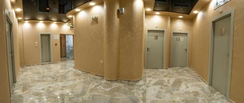 a hallway with a row of doors in a building at Hotel CITY Petrich in Petrich
