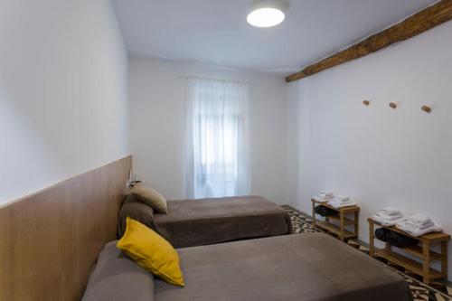 a bedroom with a bed and a desk at Hostel.B in Belorado