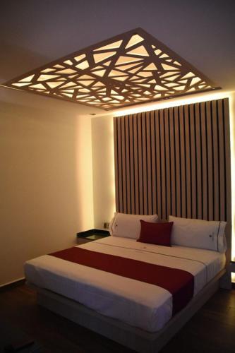 a bedroom with a large bed in a room at Amarterra Hotel Boutique in Mexico City