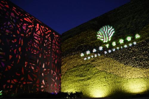 a building with a green wall with a sign on it at Amarterra Hotel Boutique in Mexico City