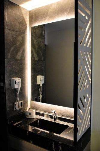 a bathroom with a sink and a mirror at Amarterra Hotel Boutique in Mexico City