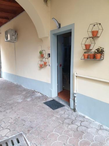 a doorway to a building with potted plants on the wall at ROMEO2 in Somma Lombardo