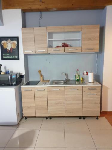 a kitchen with wooden cabinets and a sink at ROMEO2 in Somma Lombardo
