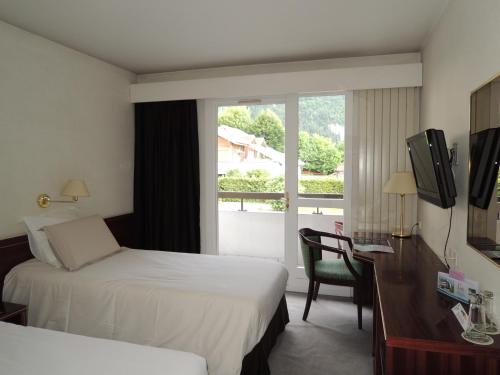 Ένα ή περισσότερα κρεβάτια σε δωμάτιο στο Hôtel 4C