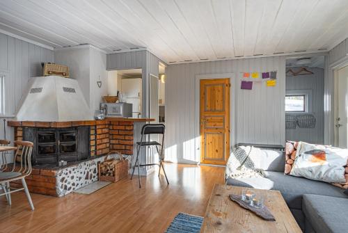 a living room with a couch and a fireplace at Gilleråsvägen 13 B in Sälen