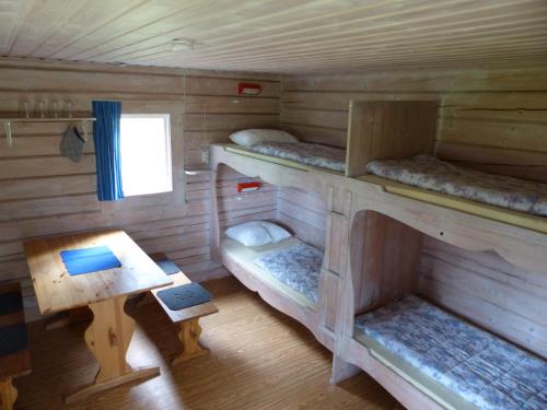 a room with two bunk beds in a cabin at Björkebo Camping in Stöllet