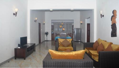 a living room with two couches and a television at NEW SITHI VILLAS in Hikkaduwa