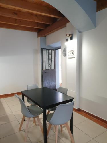 a dining room with a black table and chairs at ROMEO2 in Somma Lombardo