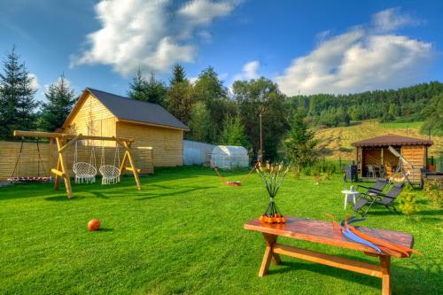 a yard with a playground with a table and a swing at Apartamenty Szwarcowa in Tylicz