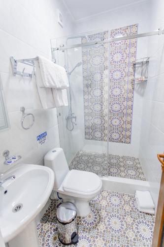 a bathroom with a toilet and a shower and a sink at Registon Saroy Hotel in Samarkand