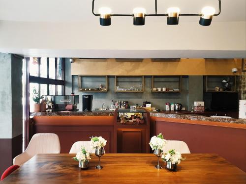 a dining room with a table and a bar at Golden House BTS Chidlom Bangkok in Bangkok