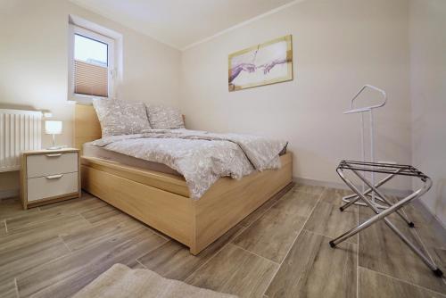 a bedroom with a bed and a lamp in it at Bungalow am Neustädter See in Neustadt-Glewe